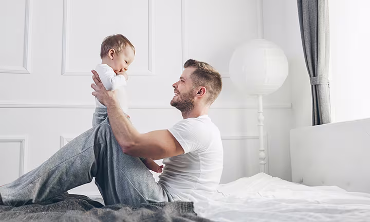 Dad playing with baby
