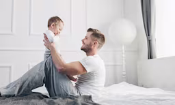 Dad playing with baby
