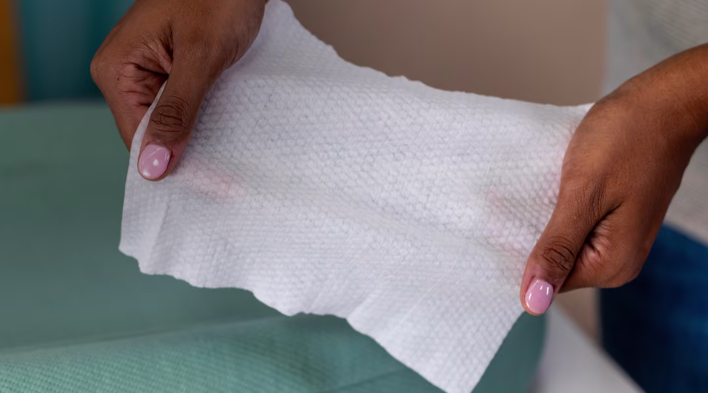 Close up of mom holding a free and gentle wipe showing how strong and thick it is