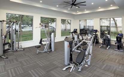 24-hour fitness center with cardio machines and strength equipment