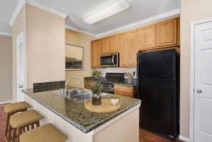 Kitchen with granite countertops and bar seating