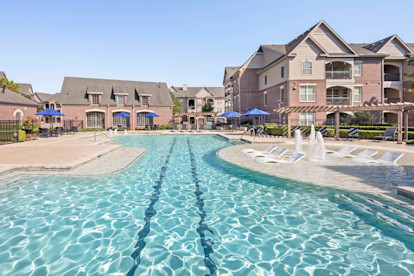 Resort-style pool with lap lane and water features at Camden Cypress Creek Apartments in Cypress, Tx