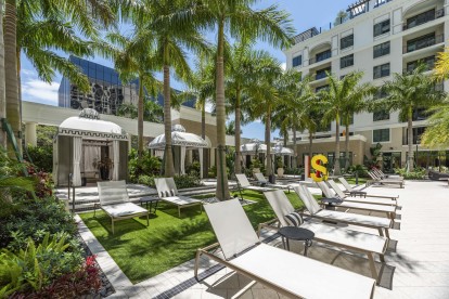 Private cabanas and plenty of lounge chairs at the tropical pool at Camden Central Apartments in St. Petersburg, FL.