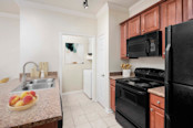 Kitchen with black appliances at Camden Woodson Park apartments in Houston, TX