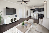 Open-concept living room and kitchen with kitchen island at Camden Franklin apartments in Franklin, TN