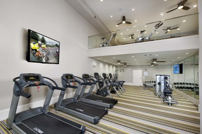 24 hour 2 story fitness center with cardio machines and free weights