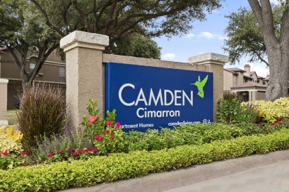 Front entry with logo sign at Camden Cimarron