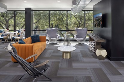 Resident lounge with seating and TV at Camden Design District apartments in Dallas, TX