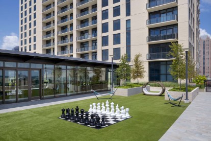 Relaxation courtyard with life size chess and hammocks