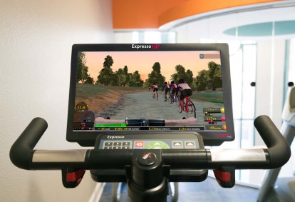 24 hour fitness center with virtual trainer on stationary bikes