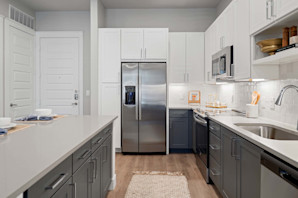 Two-tone cabinets and light gray countertops in 1-bedroom model at Camden Roanoke apartments in Roanoke, TX