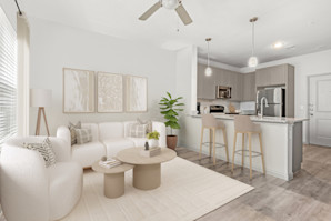 First-floor living room and kitchen with wood-style floors and extended kitchen counter at Camden Leander apartments in Leander, Tx