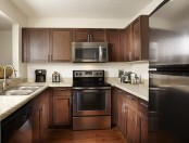 Kitchen in traditional finish style with energy efficient stainless steel appliances including microwave