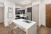 Kitchen with island, stainless steel appliances, and modern cabinets at Camden Victory Park apartments in Dallas, TX