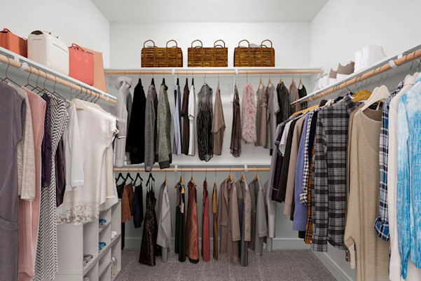 Large walk-in closet with built-in wood shelves and racks at Camden Greenville