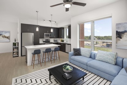 Open-concept living room and kitchen at Camden Rainey Street