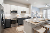 Two-tone kitchen cabinets and island at Camden Roanoke apartments in Roanoke, TX