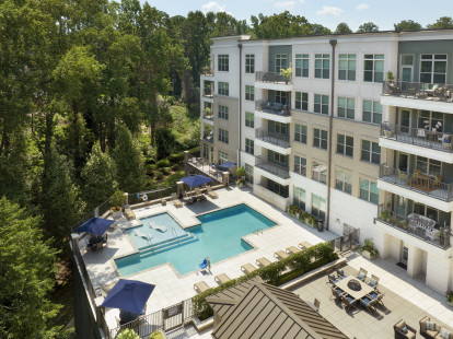 Outdoor lounge area with fire pits and resort-style pool