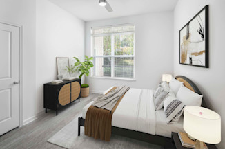 Spacious bedroom with wood-style flooring at Camden Dulles Station apartments in Herndon, VA