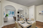 Classic style dining room with arched entry to living room