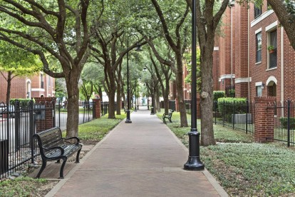 Walking path with benches and trees within the community