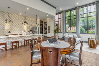 Resident lounge with entertaining kitchen and poker tables at Camden Gallery Apartments in Charlotte, NC