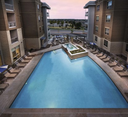 Swimming pool at dusk at Camden Lincoln Station Apartments in Lone Tree, CO