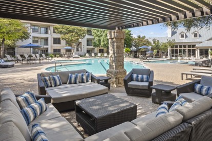 Poolside covered seating lounge at Camden Stoneleigh apartments in Austin, TX