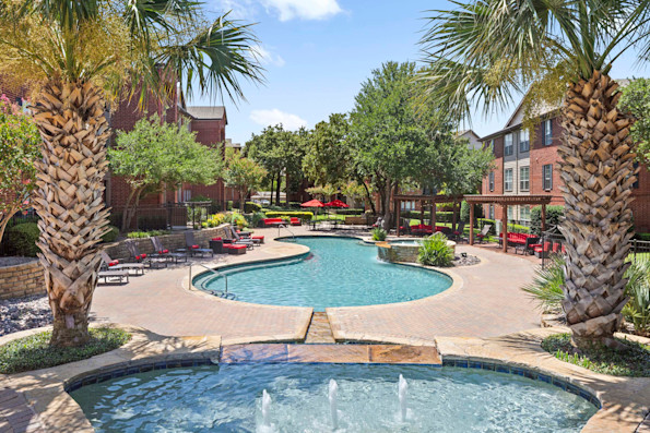 Resort-style pool with spacious sundeck and fountain at Camden Centreport apartments in Fort Worth, TX