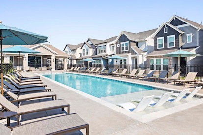 Resort-style pool with sun loungers and umbrellas at Camden Long Meadow Farms Homes for rent in Richmond, Tx