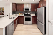 Warm modern style features an open-concept kitchen and dining space at Camden NoMa apartments in Washington, D.C.