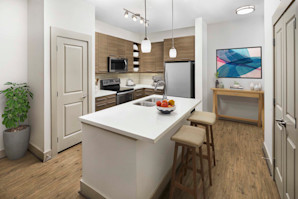 Kitchen with breakfast bar and wood-style flooring at Camden Lincoln Station Apartments in Lone Tree, CO