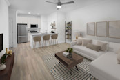 Open-concept living room and kitchen with wood-style flooring at Camden Shadow Brook apartments in Austin, TX