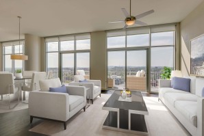Camden Music Row Apartments Penthouse living room with floor-to-ceiling windows, large balcony with a view, ceiling fans, and hardwood-style flooring