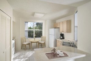 Kitchen with laminate countertops white appliances and breakfast nook