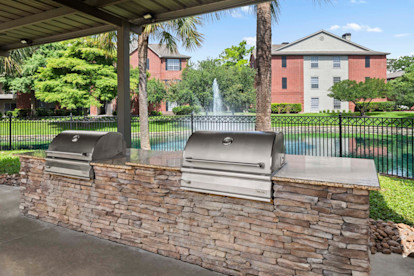 Poolside BBQ grills at Camden Holly Springs apartments in Houston, TX