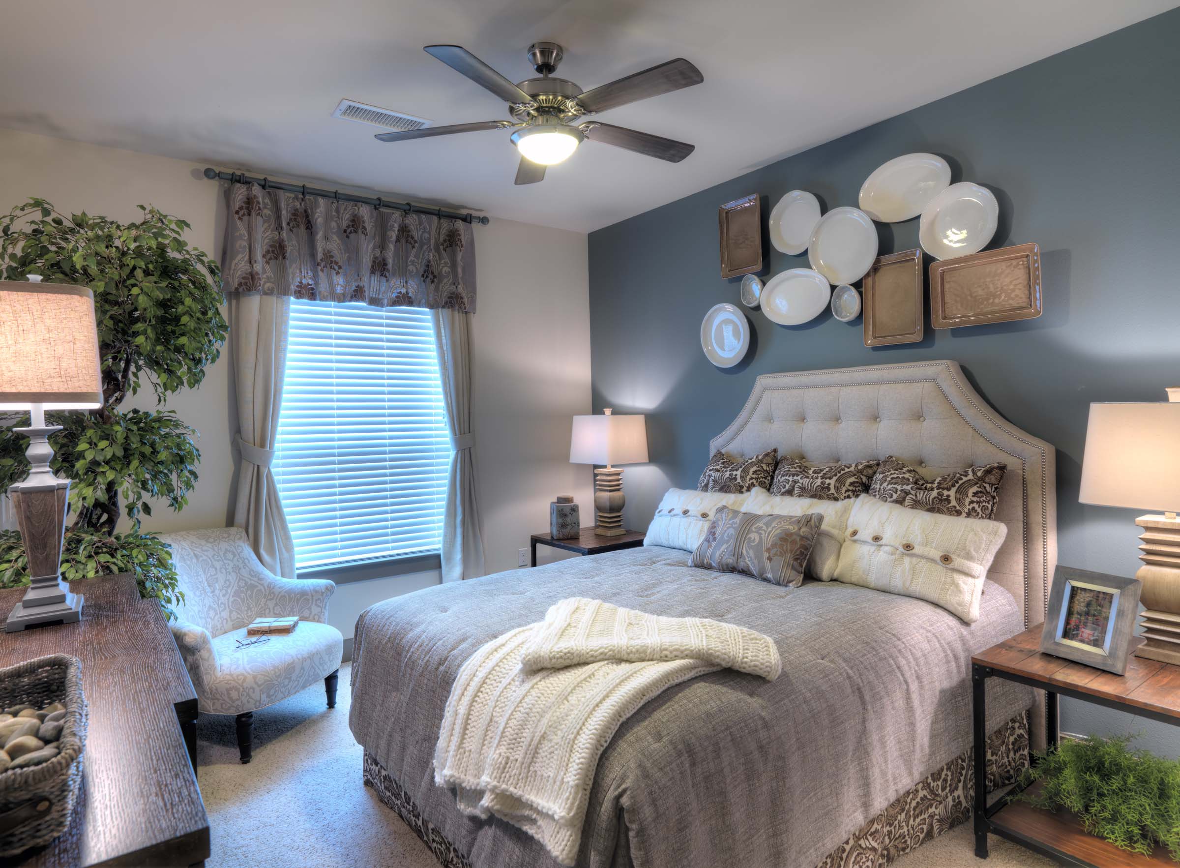 Bedroom with accent wall and ceiling fan