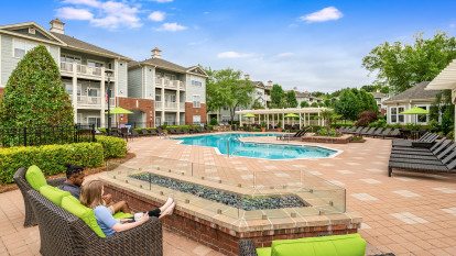 Firepit and seating area alongside pool at Camden Governors Village Apartments in Chapel Hill, NC