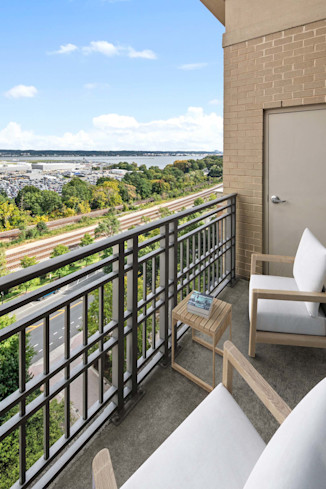 Private balcony with space for outdoor furniture at Camden Potomac Yard Apartments in Arlington, VA. 