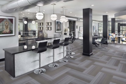 Resident lounge with kitchen and bar top at Camden Design District apartments in Dallas, TX