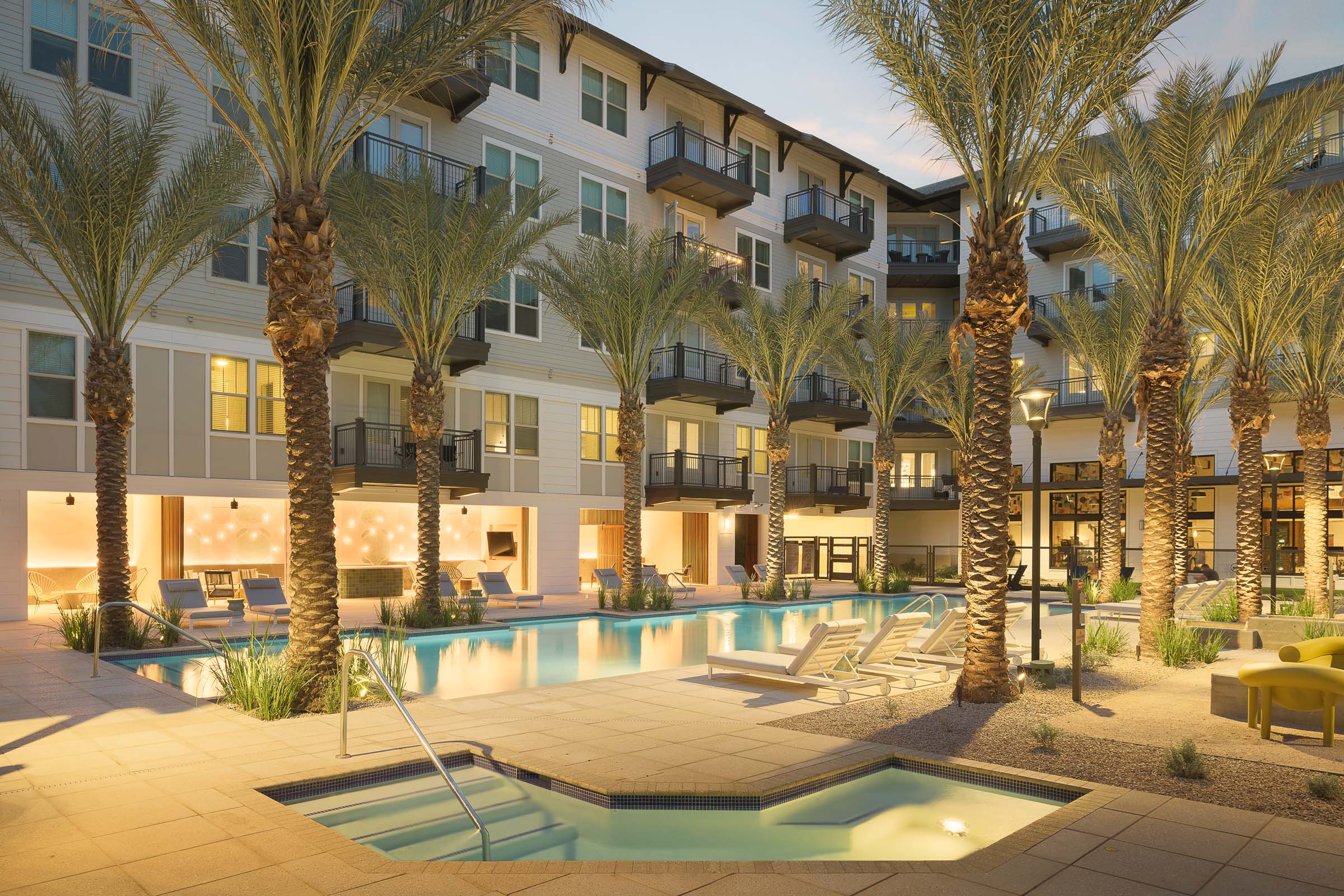 Oasis-style pool with hot tub and palm trees at Camden Gilbert apartment homes in Gilbert, AZ