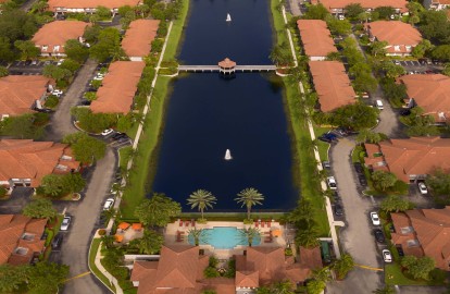 View of lakeside pool surrounded by groomed landscaping