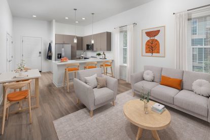 Modern Finish open concept living room with breakfast bar at Camden Lakeway Apartments in Lakewood, CO