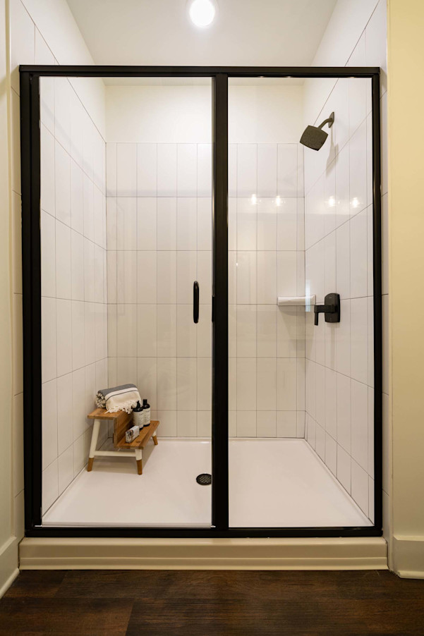 Glass-enclosed shower with modern tile surround at Camden West Nashville apartments in Nashville, TN