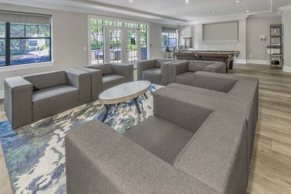 Resident lounge with billiards table, lounge seating, and cloud printer