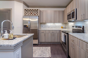 Kitchen with wine bottle storage in Camden Alpharetta apartments in Alpharetta, GA