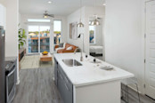 Kitchen with large islands, pendant lighting, white upper and gray lower cabinets