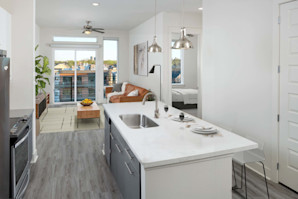 Kitchen with large islands, pendant lighting, white upper and gray lower cabinets