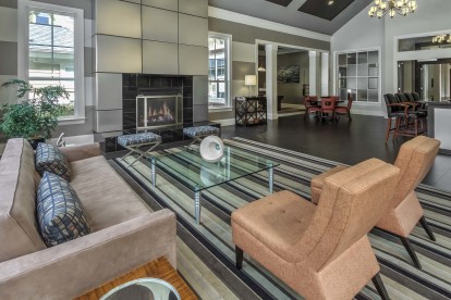 Resident lounge with electric fireplace and entertaining kitchen