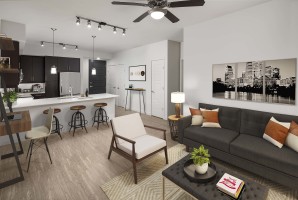 Open-concept floor plan with wood-style flooring and space to work from home at Camden Rainey Street apartments in Austin, TX